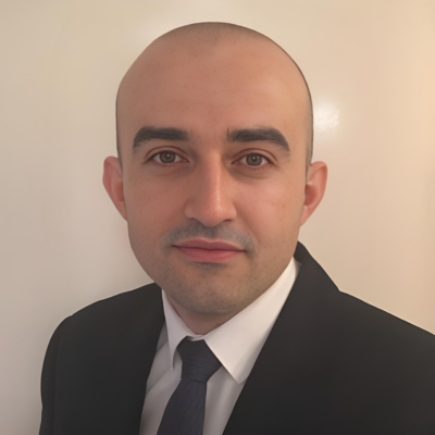 A headshot image of a man dressed in a formal suit